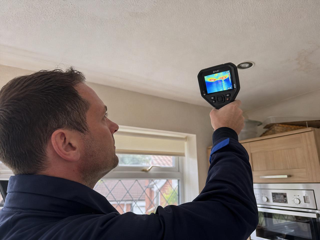 Captura specialist using thermal imaging camera to trace a hidden water leak